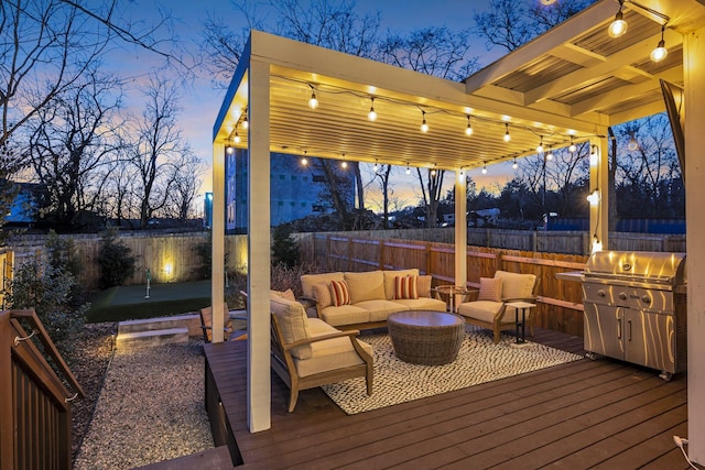 deck at dusk with an outdoor living space and a grill