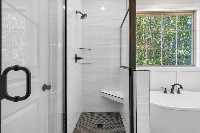 bathroom featuring separate shower and tub