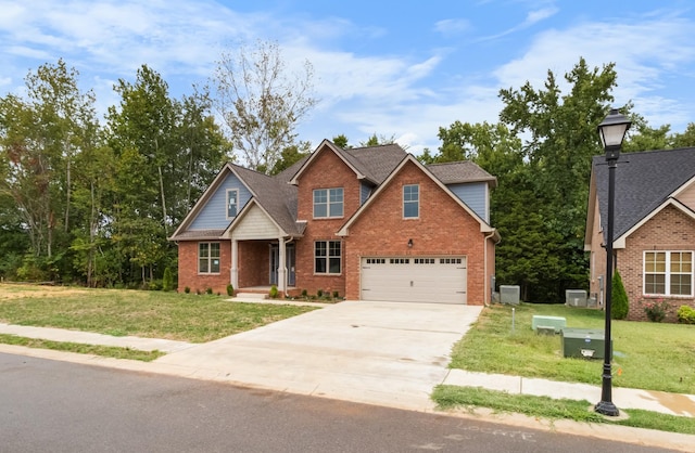 craftsman inspired home with a garage and a front lawn