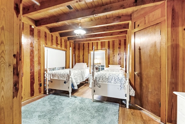 bedroom featuring wooden ceiling, beamed ceiling, and light wood-type flooring