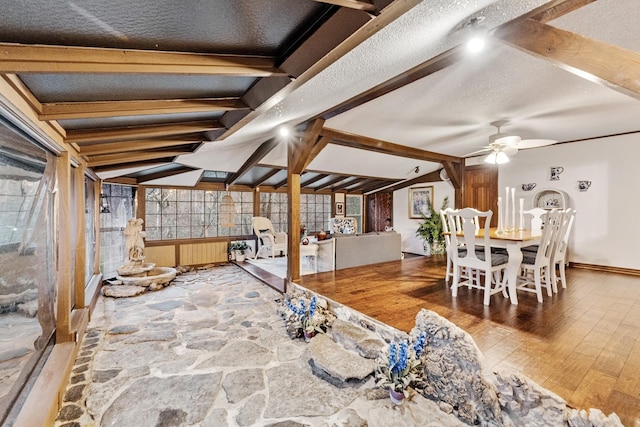 basement featuring ceiling fan, hardwood / wood-style floors, and a textured ceiling