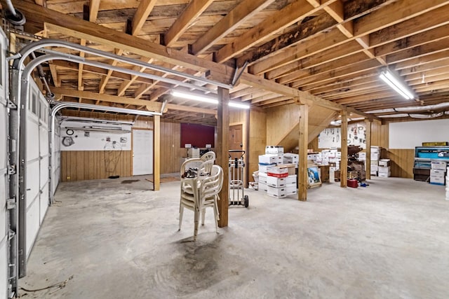 basement featuring wood walls