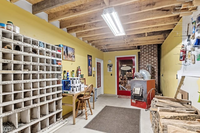 interior space featuring concrete flooring and a wood stove