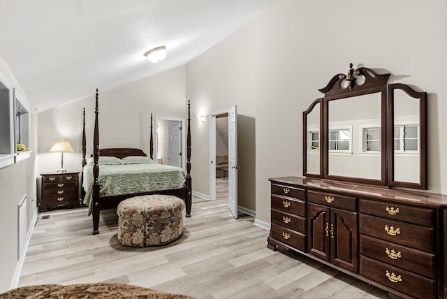 bedroom with lofted ceiling and light hardwood / wood-style floors