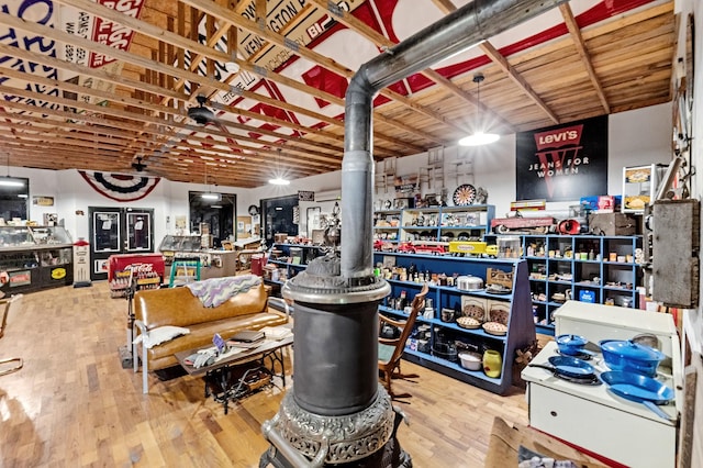 miscellaneous room featuring hardwood / wood-style flooring and a wood stove