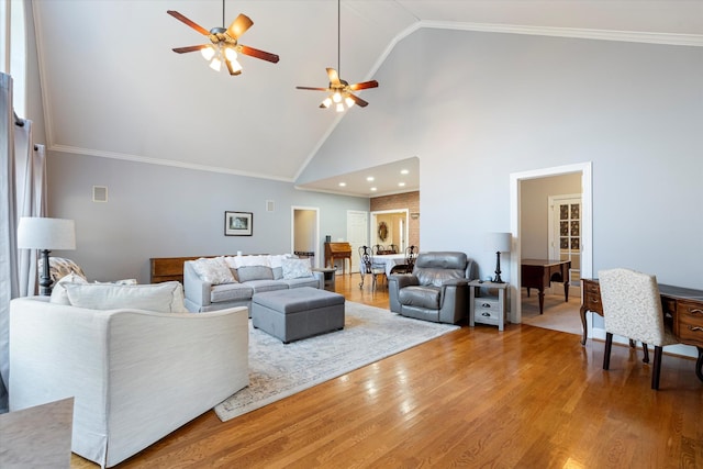 living room with crown molding, wood-type flooring, high vaulted ceiling, and ceiling fan