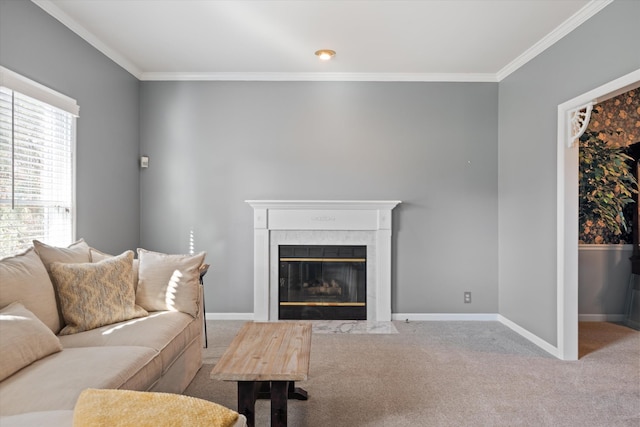 living room with crown molding, a tile fireplace, and carpet