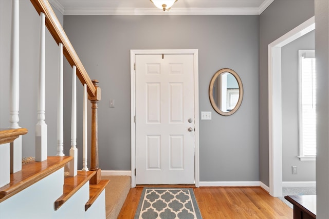 entryway featuring crown molding and light hardwood / wood-style flooring