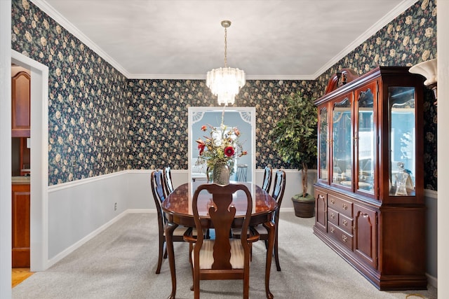 dining area with light colored carpet, ornamental molding, and a chandelier