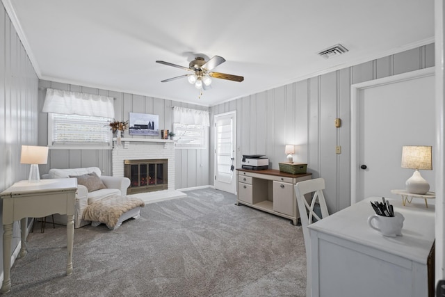 interior space featuring a brick fireplace, ornamental molding, and ceiling fan