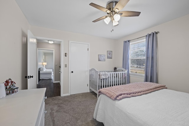 bedroom featuring ceiling fan and dark carpet