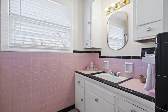 bathroom with vanity and tile walls