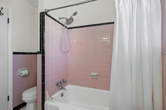 bathroom with shower / bath combo, tile walls, and toilet