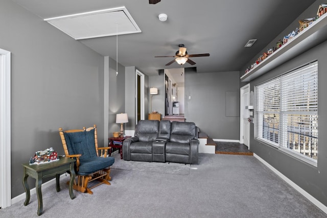 carpeted living room with ceiling fan