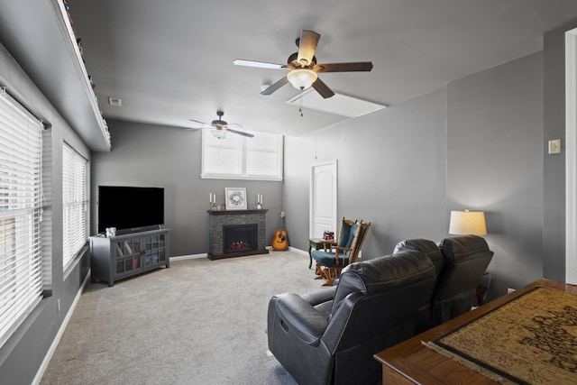 living room featuring ceiling fan, carpet flooring, and a fireplace