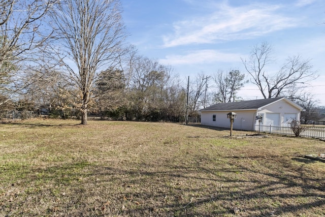 view of yard featuring a garage and an outdoor structure