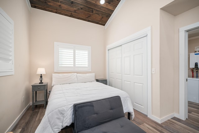 bedroom with dark hardwood / wood-style flooring, lofted ceiling, wood ceiling, and a closet