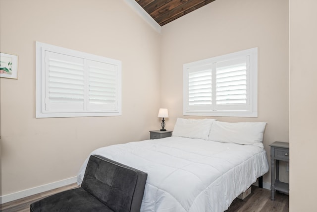 bedroom featuring lofted ceiling, dark wood-type flooring, and wood ceiling