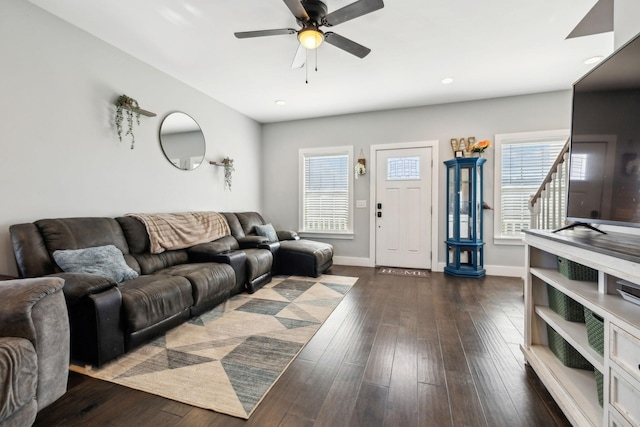 living room with ceiling fan, a healthy amount of sunlight, and dark hardwood / wood-style floors