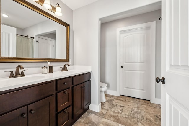 bathroom with vanity and toilet