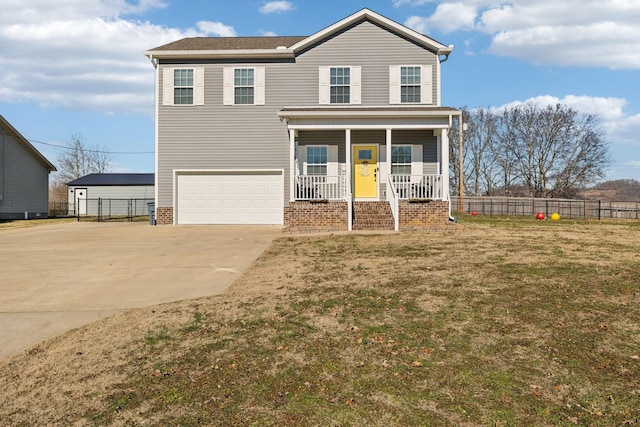 view of front of house featuring a garage, a porch, and a front yard