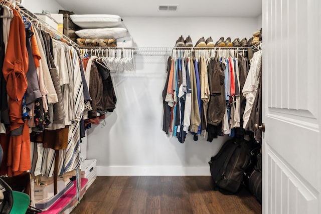 walk in closet featuring dark hardwood / wood-style flooring