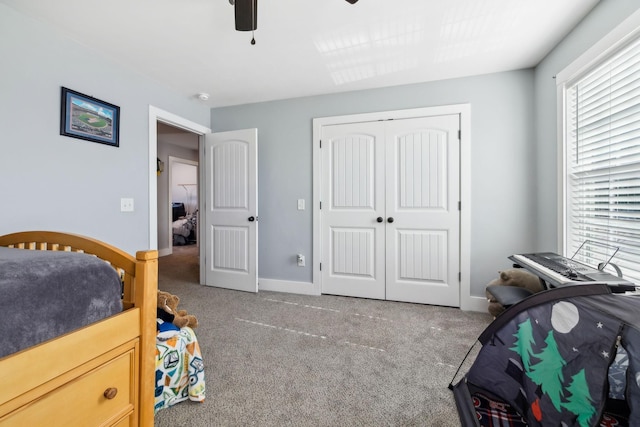 carpeted bedroom with a closet and ceiling fan