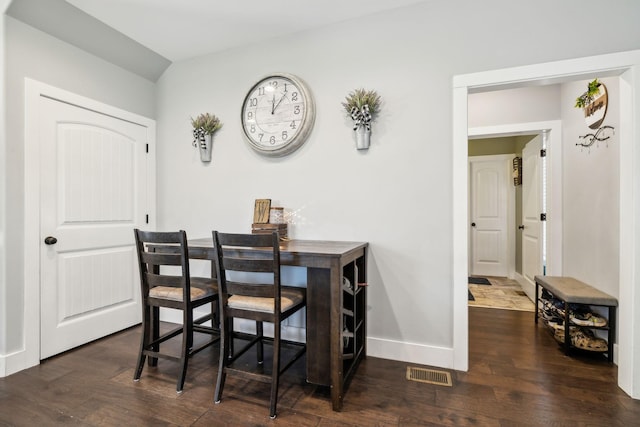 dining area with dark wood-type flooring