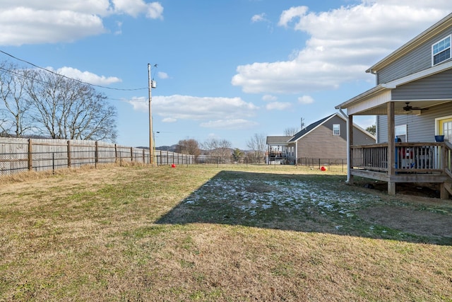 view of yard featuring a wooden deck and ceiling fan