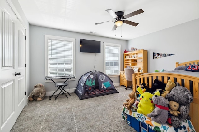 bedroom featuring multiple windows, ceiling fan, and carpet