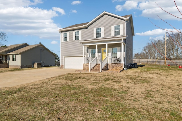 view of front of home with a garage, a front yard, and covered porch