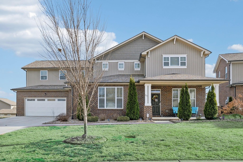 view of front of property featuring a garage and a front yard