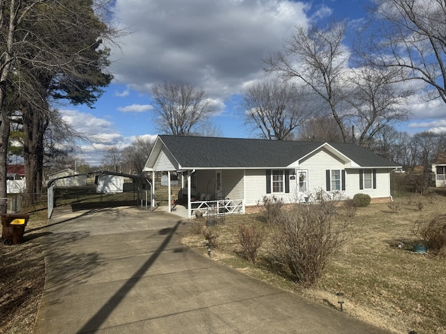 view of front of home with a carport and a porch