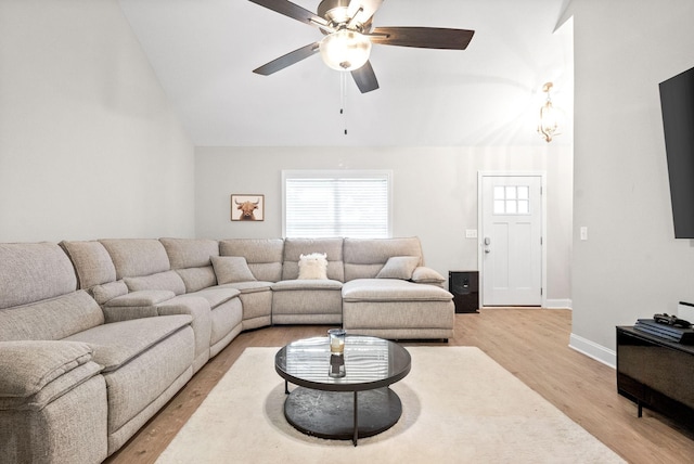 living room with ceiling fan, lofted ceiling, and light wood-type flooring