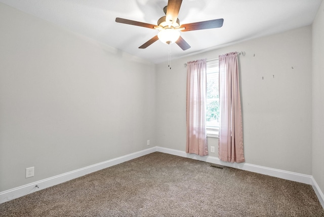 carpeted spare room featuring ceiling fan