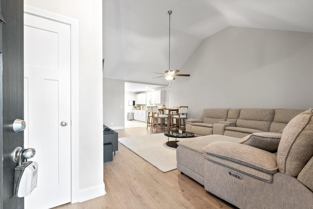 living room featuring ceiling fan, lofted ceiling, and hardwood / wood-style floors