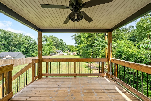 deck featuring ceiling fan and a lawn