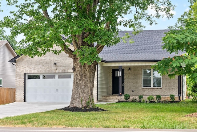 view of front of home featuring a garage and a front yard