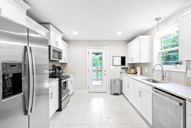 kitchen featuring sink, white cabinets, and appliances with stainless steel finishes