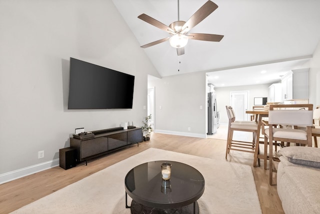 living room with high vaulted ceiling, light hardwood / wood-style floors, and ceiling fan