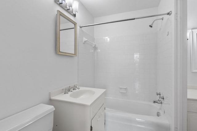 full bathroom featuring tiled shower / bath combo, vanity, and toilet