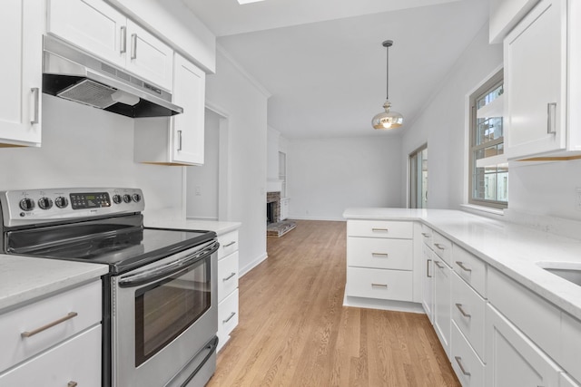 kitchen featuring white cabinetry, decorative light fixtures, stainless steel range with electric cooktop, and light wood-type flooring