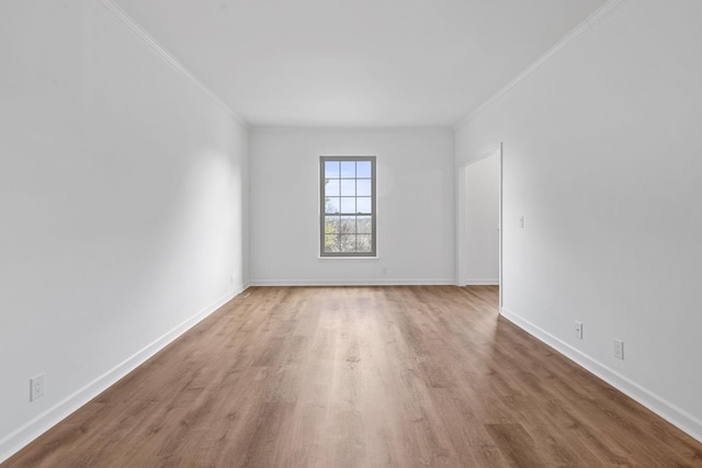 spare room with ornamental molding and hardwood / wood-style floors