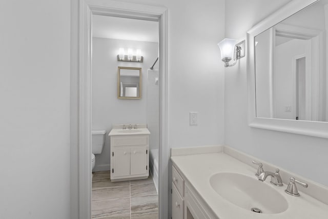 bathroom with tile patterned flooring, vanity, and toilet