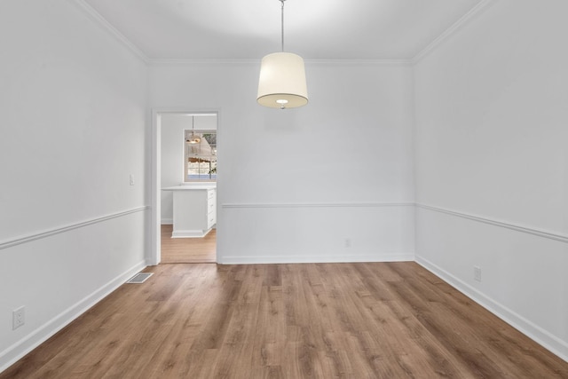 unfurnished dining area featuring hardwood / wood-style floors and ornamental molding