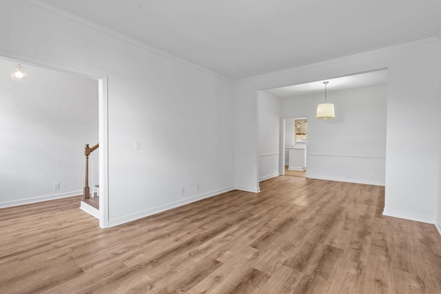 unfurnished room with crown molding and light wood-type flooring