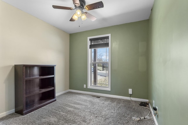 empty room with ceiling fan and carpet flooring