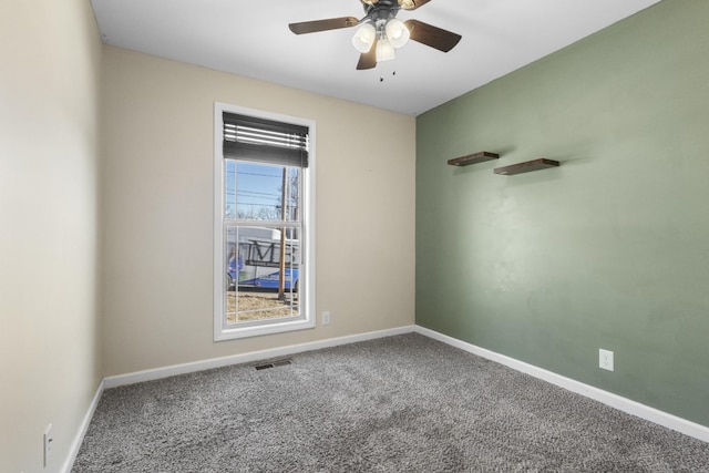 unfurnished room featuring ceiling fan and carpet