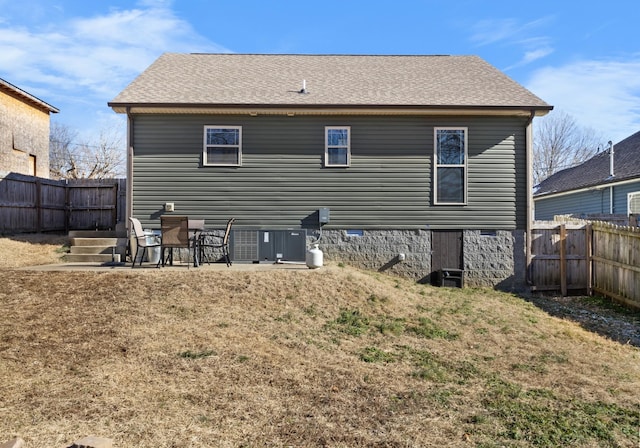 rear view of property with a yard and a patio area