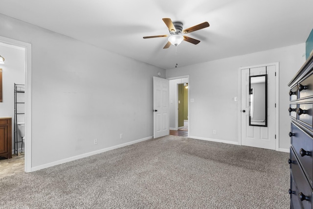 unfurnished bedroom featuring ceiling fan, ensuite bath, and carpet flooring